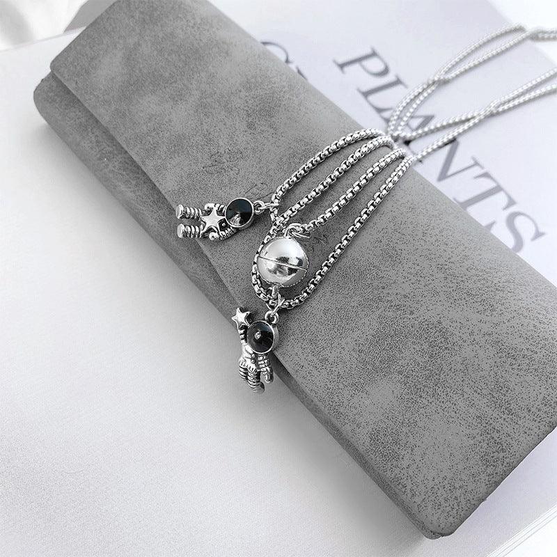 Cosmic Bond – Dual Astronaut Pendant Set