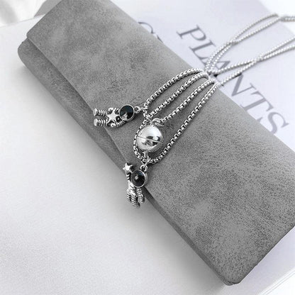 Cosmic Bond – Dual Astronaut Pendant Set